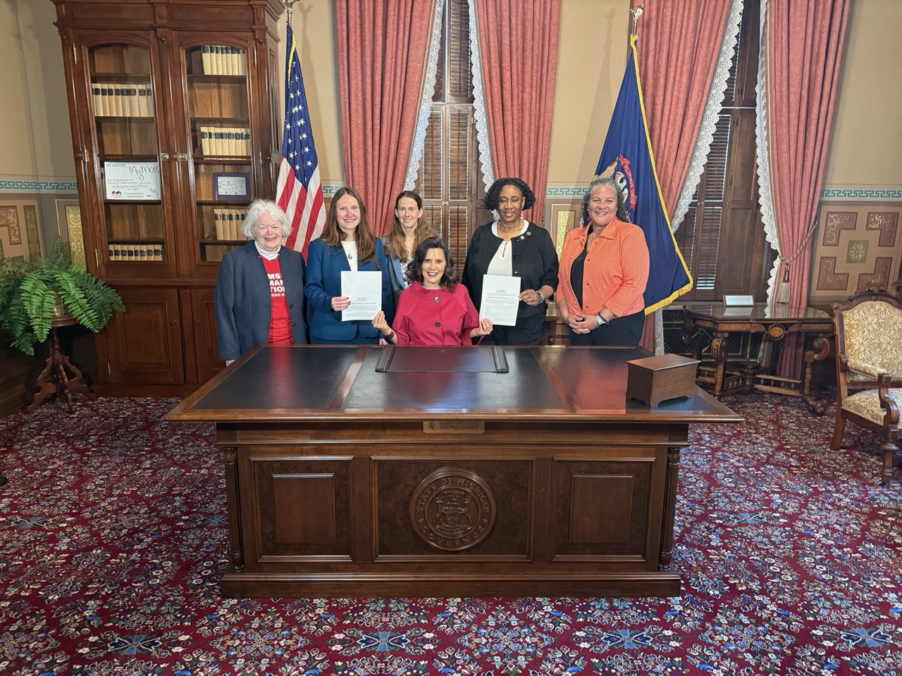 Melanie Macey with Gov. Whitmer at a bill signing