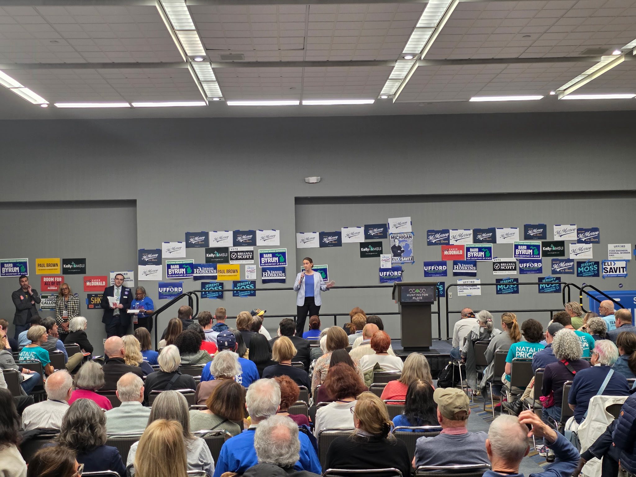 Macey speaks in front of a large crowd
