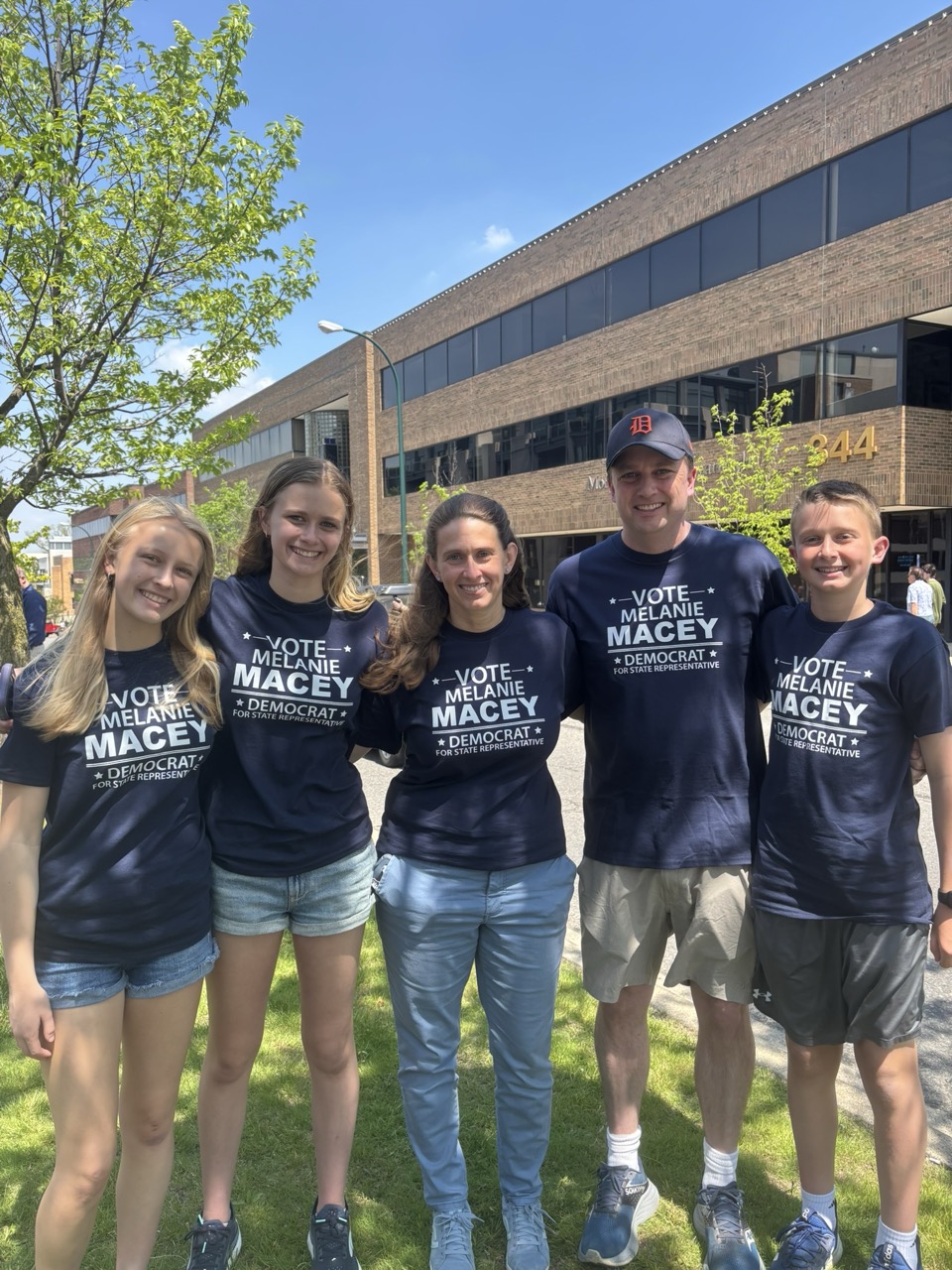 Melanie Macey with her husband and children, wearing matching campaign shirts