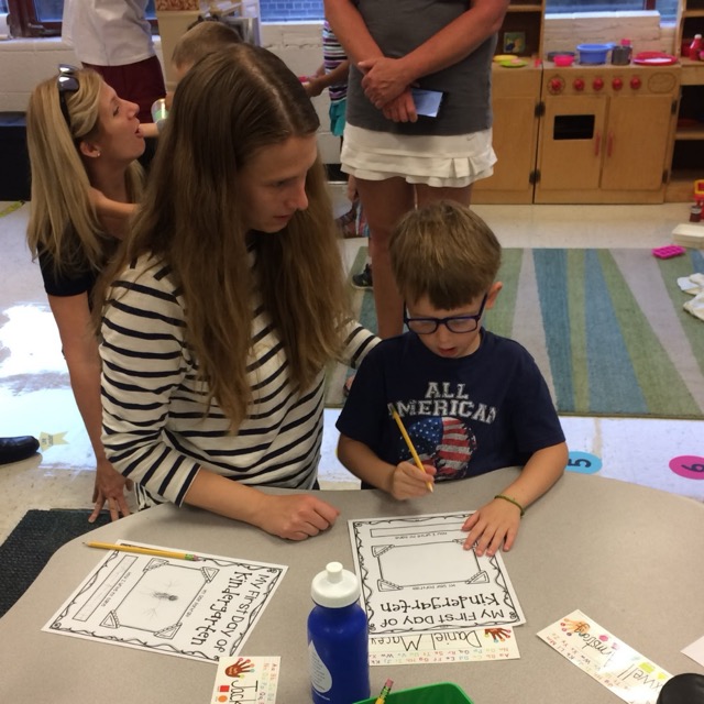 Macey with a child coloring at school